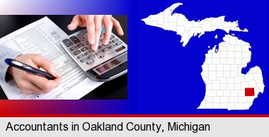 an accountant at work; Oakland County highlighted in red on a map